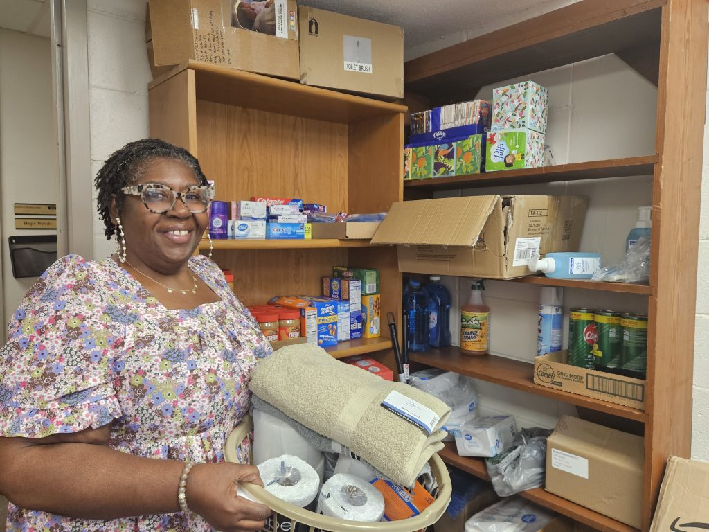 Executive Coordinator Tracy Coleman posed with donated items