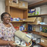 Executive Coordinator Tracy Coleman posed with donated items