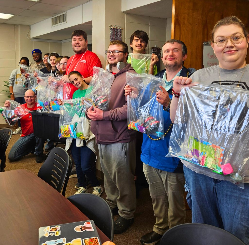 Members of the Community Volunteer Club holding up completed sensory kits.