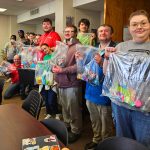 Members of the Community Volunteer Club holding up completed sensory kits.
