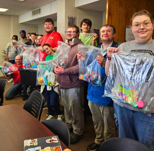 Members of the Community Volunteer Club holding up completed sensory kits.