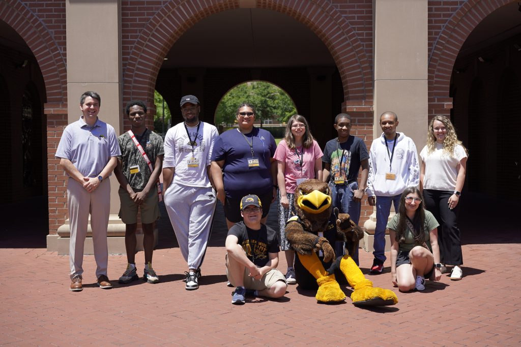 RISE Summer College Readiness Program students stand in front of Luckyday Hall on Southern Miss campus.